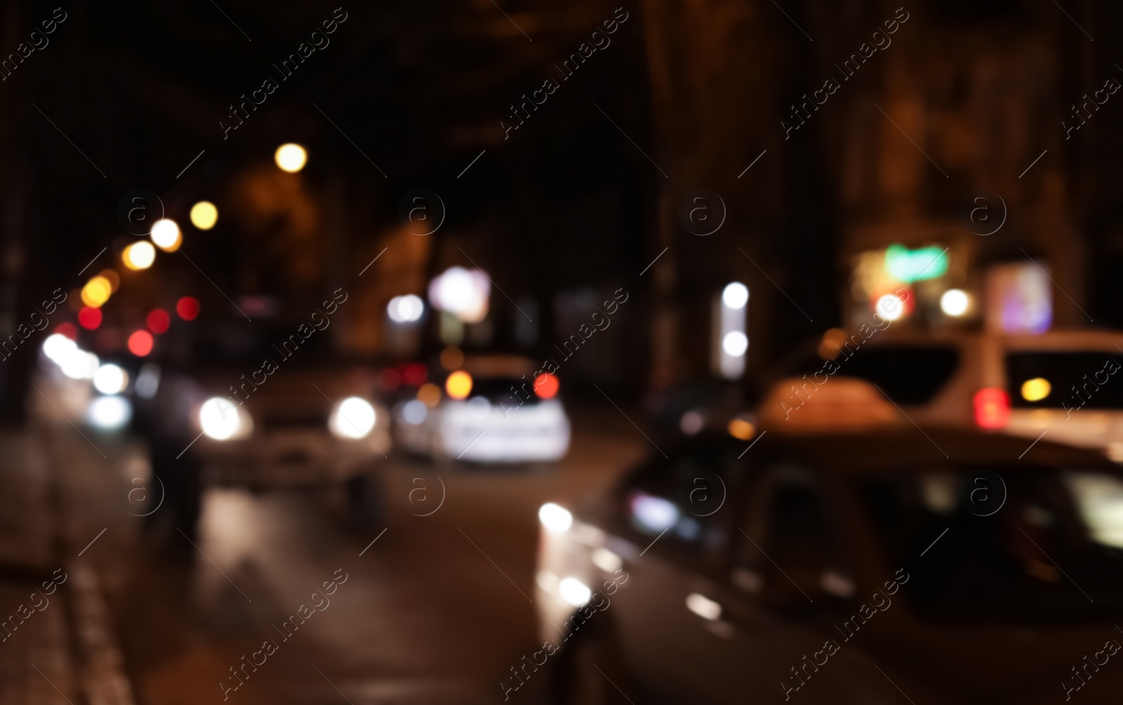 Photo of Blurred view of city street with traffic at night