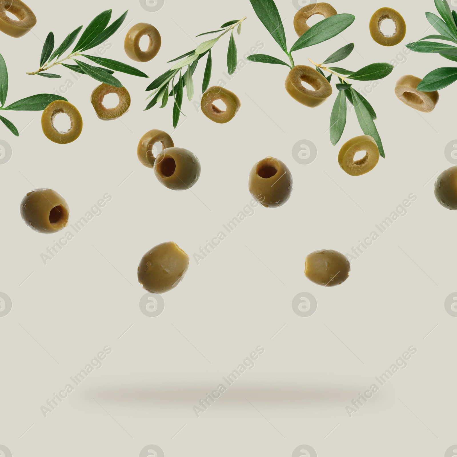 Image of Fresh olives and leaves falling on light grey background