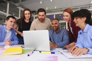 Team of employees working together at table in office. Startup project