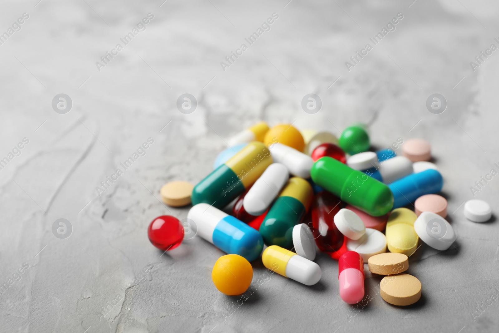 Photo of Heap of different pills on table, closeup. Space for text