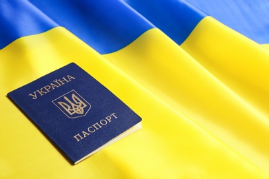 Photo of Ukrainian internal passport on national flag, space for text