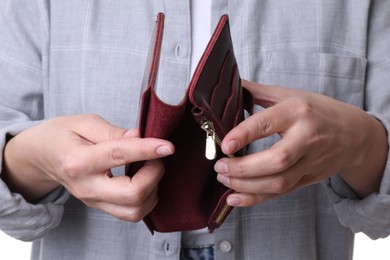 Photo of Poor woman with empty wallet, closeup view