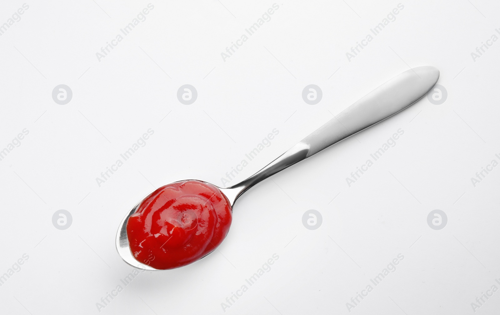 Photo of Tasty homemade tomato sauce in spoon on white background, top view