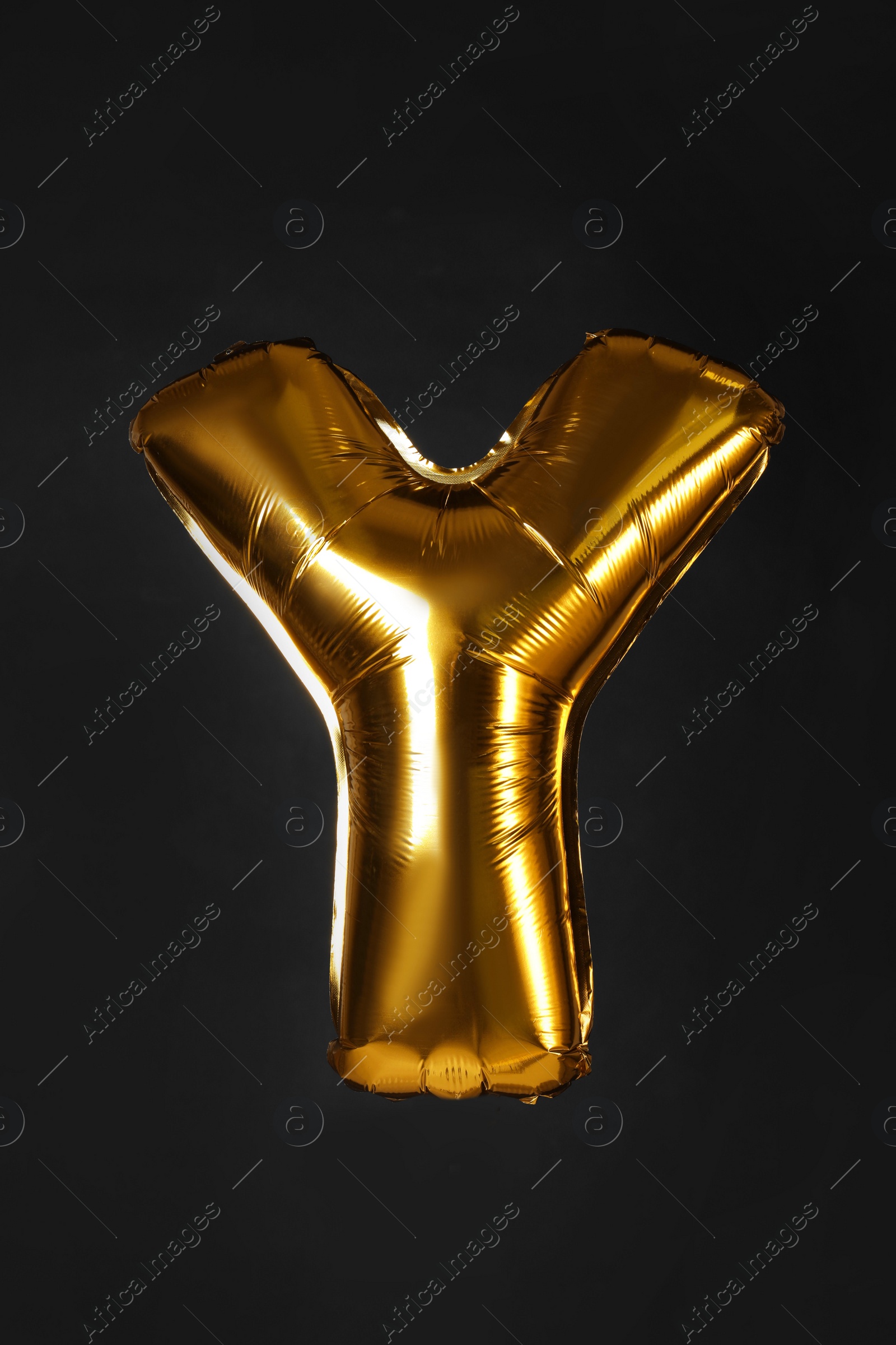 Photo of Golden letter Y balloon on black background