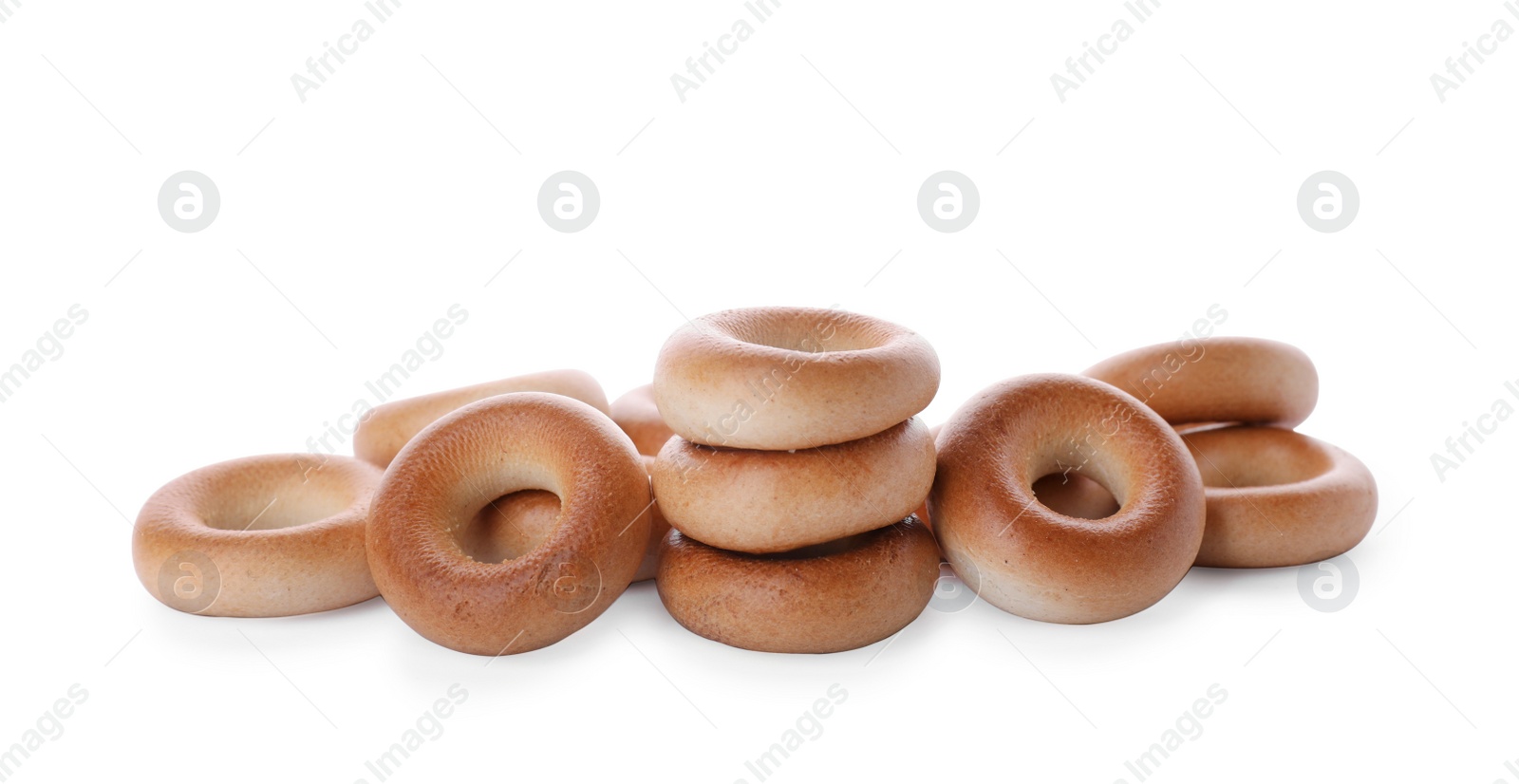 Photo of Pile of tasty dry bagels (sushki) on white background