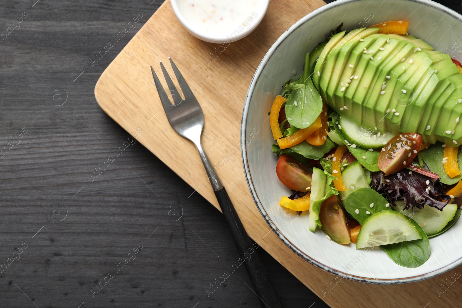 Photo of Healthy dish high in vegetable fats on black wooden table, top view. Space for text