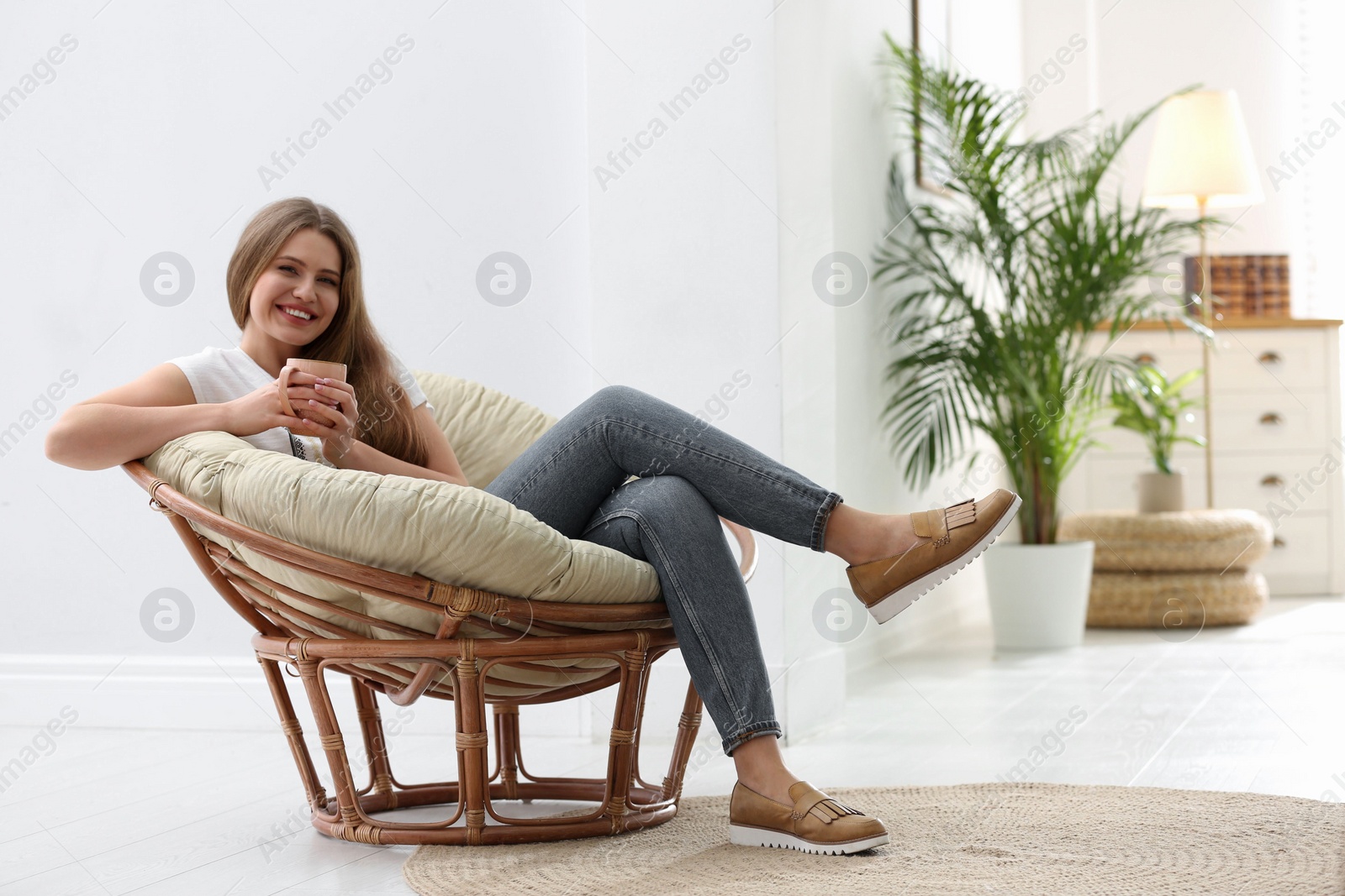 Photo of Young woman resting in armchair at home