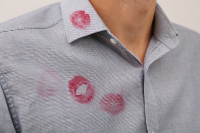 Photo of Man in shirt with lipstick kiss marks, closeup