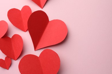 Photo of Paper hearts on pink background, flat lay. Space for text