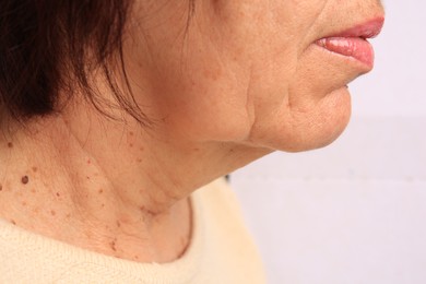 Photo of Closeup view of woman with aging skin on white background