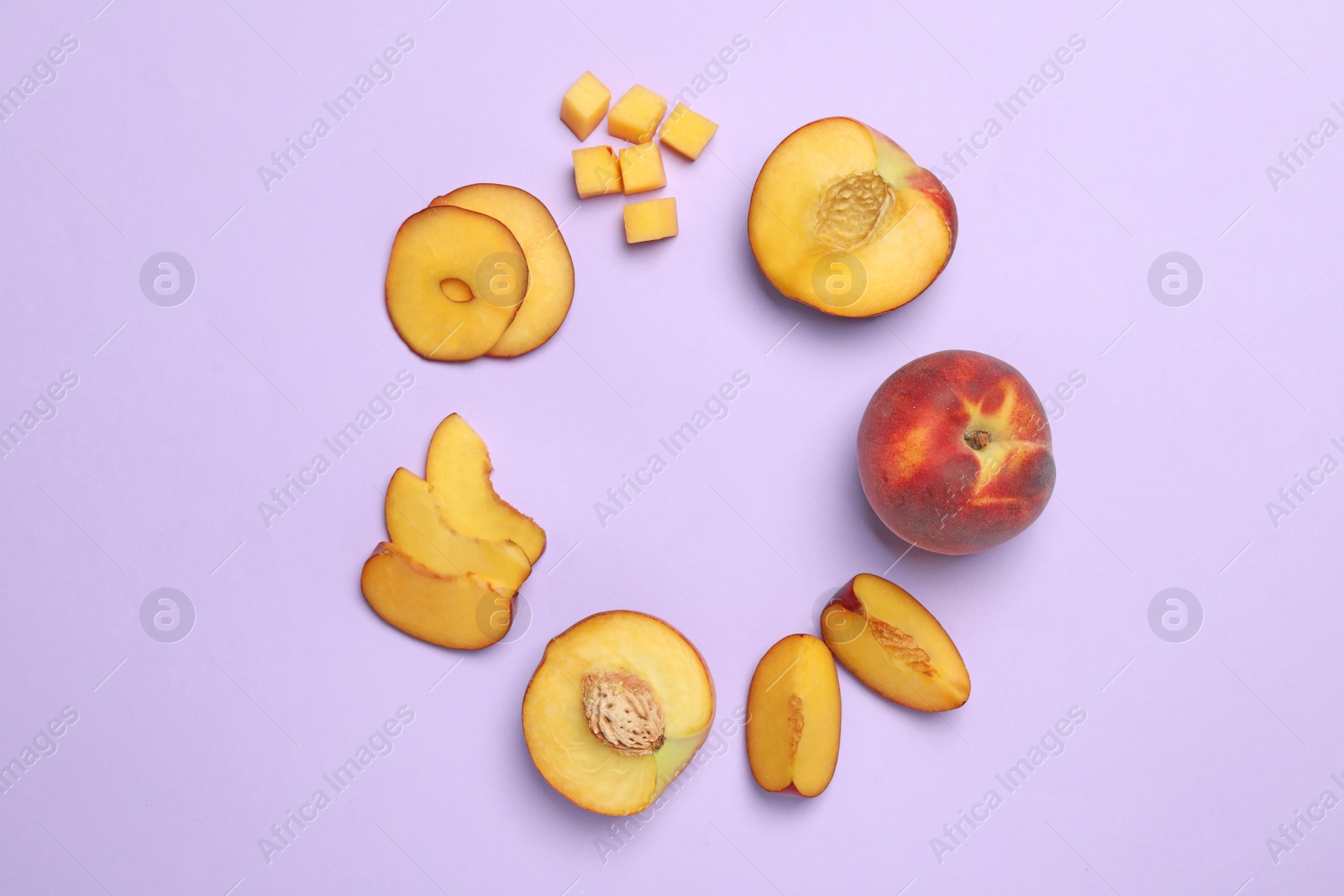 Photo of Frame made of sweet juicy peaches on lilac background, flat lay. Space for text