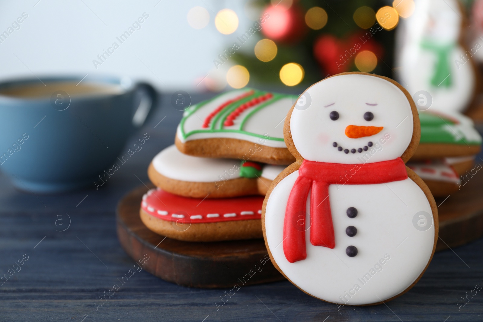 Photo of Decorated Christmas cookies on blue wooden table