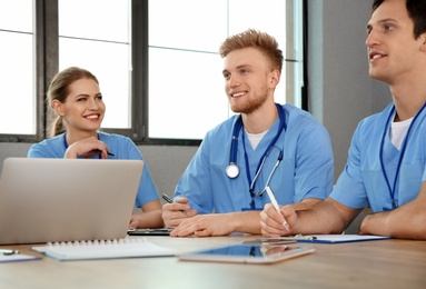 Medical students in uniforms studying at university