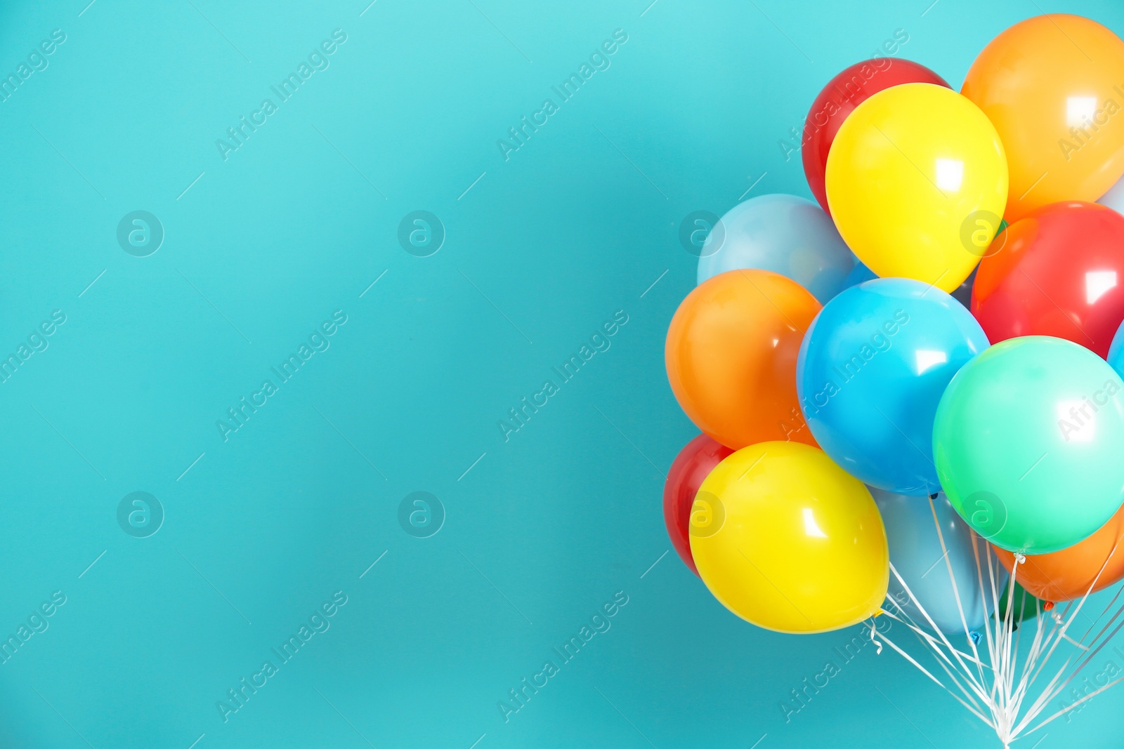 Photo of Bunch of bright balloons and space for text against color background