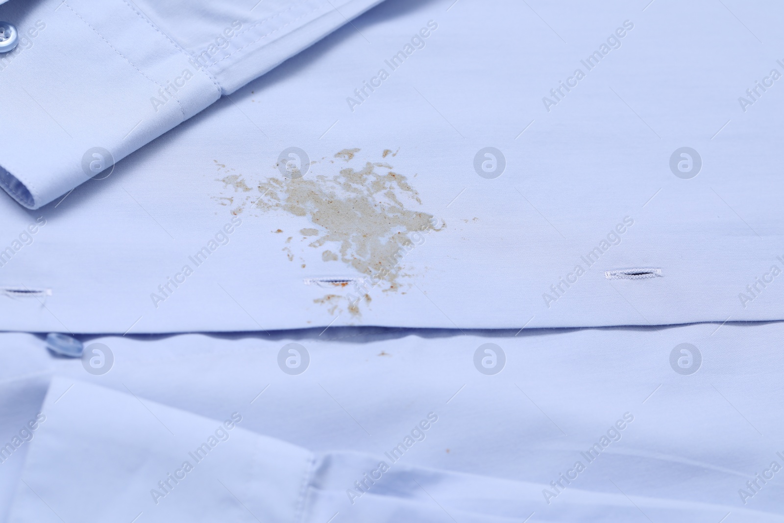 Photo of Closeup view of light blue shirt with stain