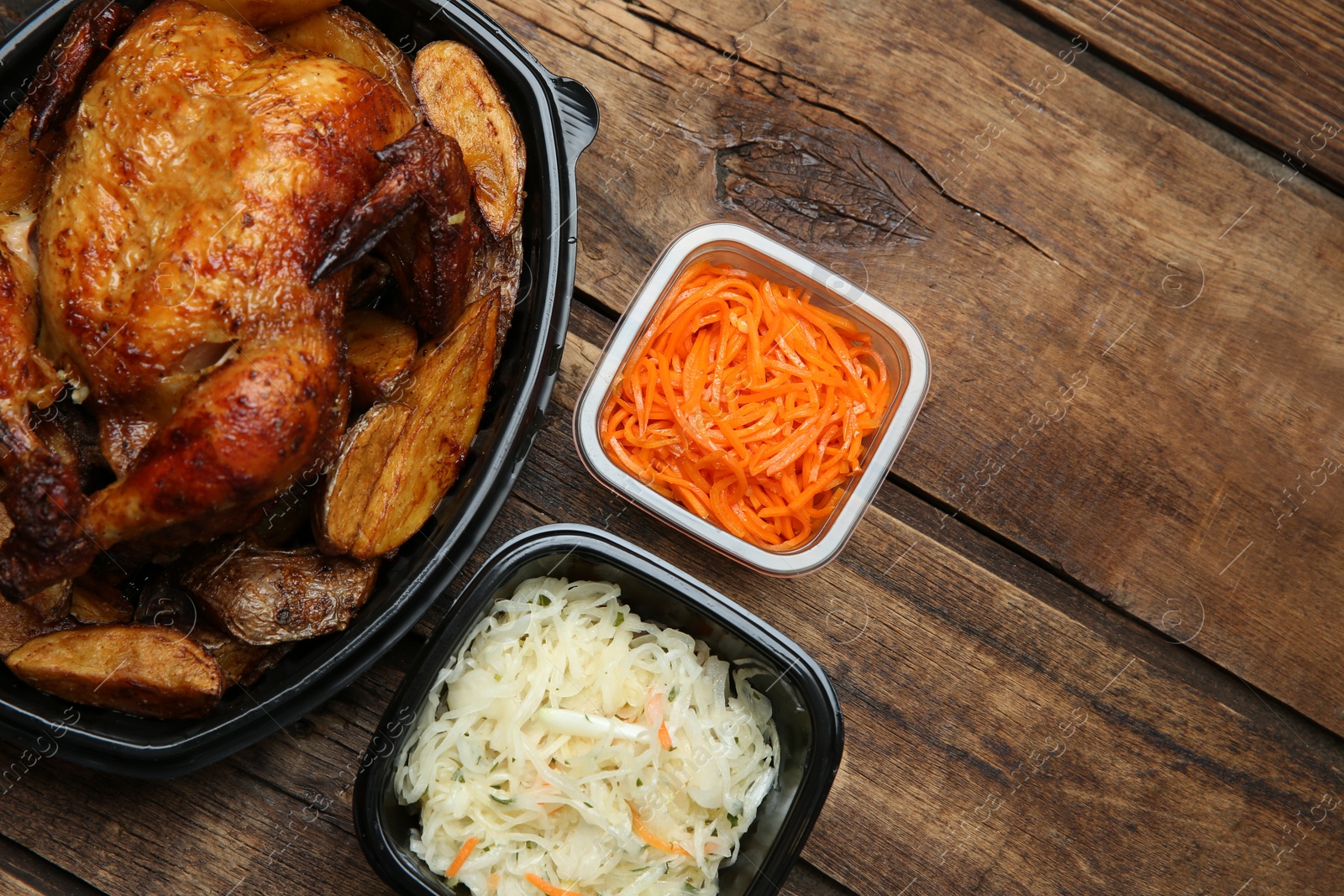 Photo of Plastic containers with different dishes on wooden table, flat lay. Food delivery service