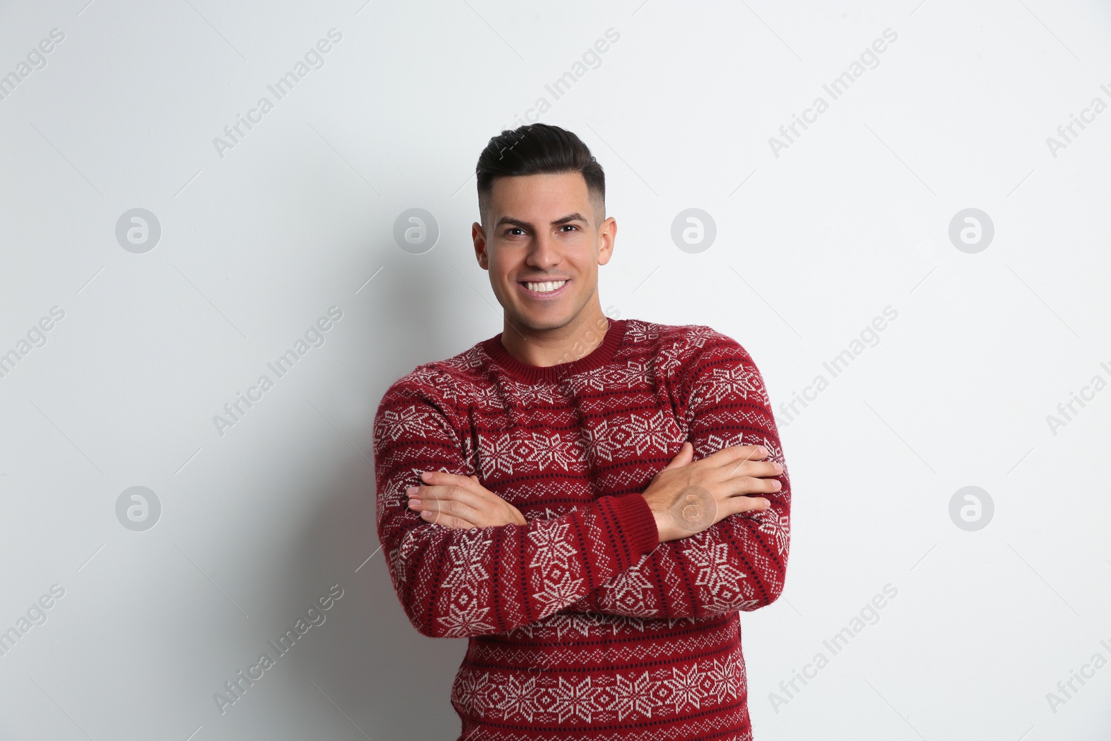 Photo of Happy man in Christmas sweater on white background