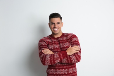 Photo of Happy man in Christmas sweater on white background