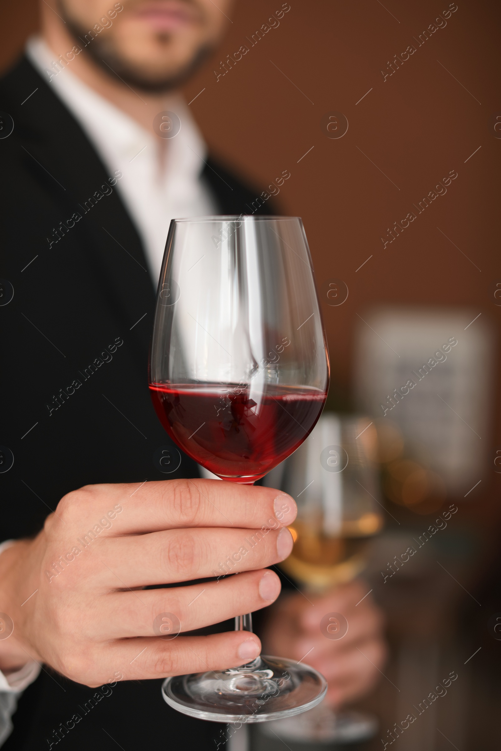 Photo of Young man with glass of wine indoors