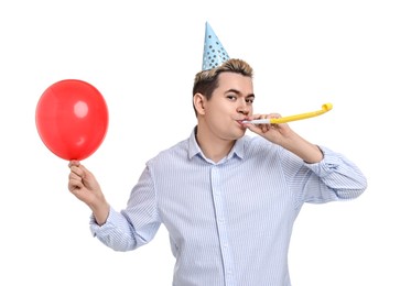 Photo of Young man with party hat, blower and balloon on white background