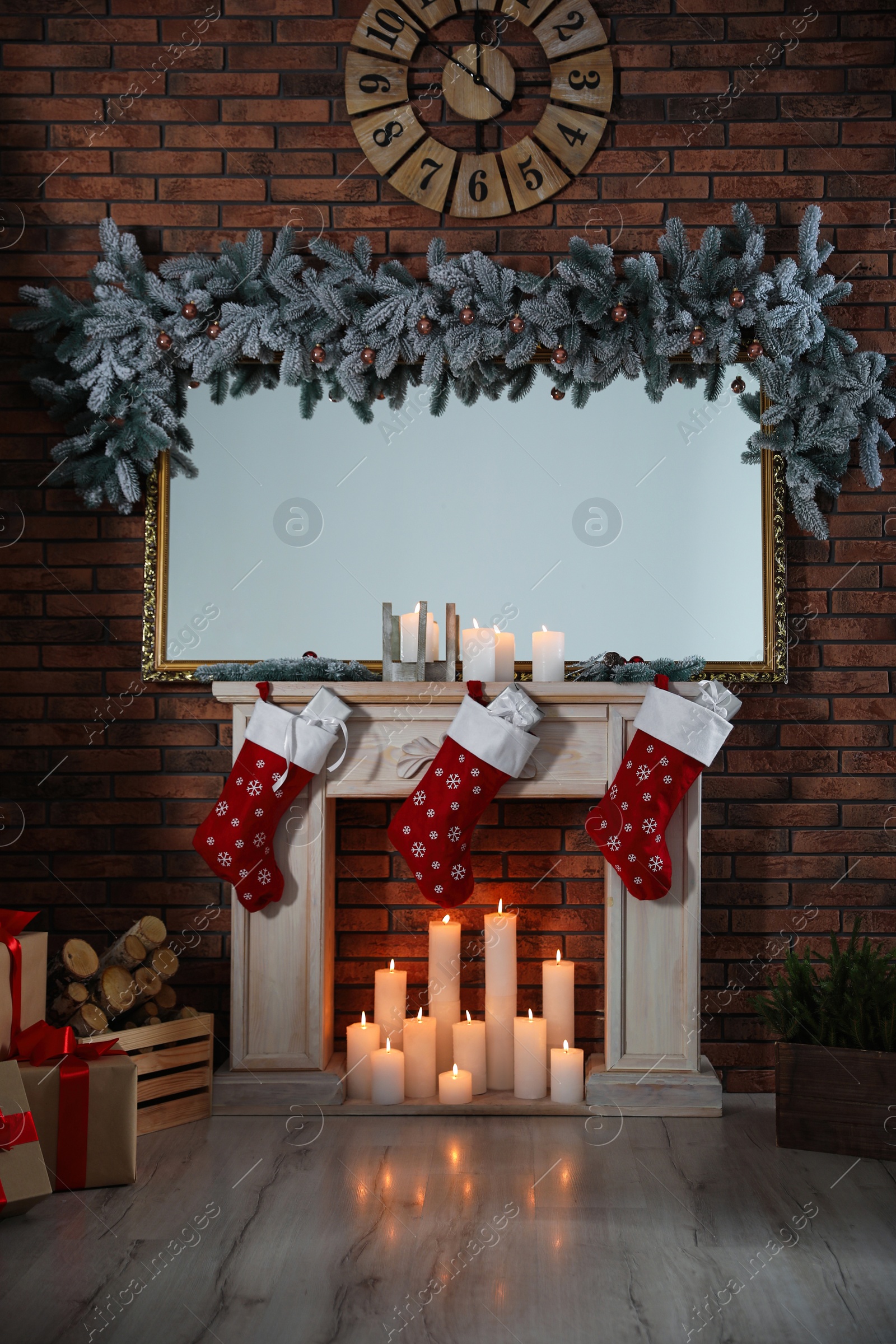 Photo of Beautiful fireplace with garland and Santa socks in Christmas room interior