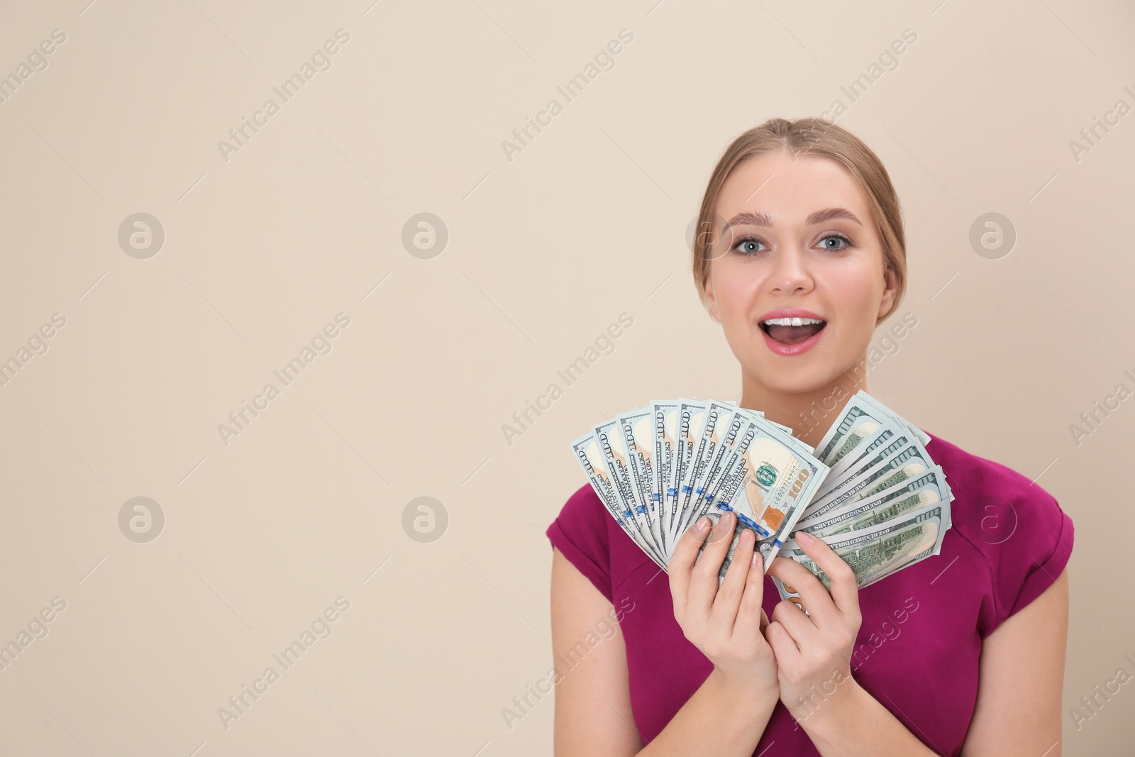 Photo of Portrait of happy young woman with money on color background. Space for text