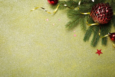 Photo of Red baubles, fir branches and streamer on shiny background, flat lay with space for text. Happy New Year