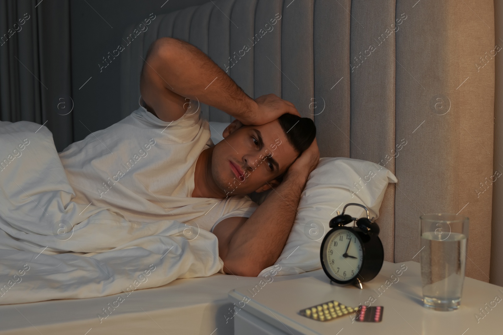 Photo of Man suffering from insomnia in bed at home