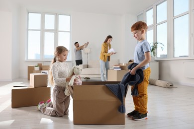 Photo of Happy family settling into new house and unpacking boxes. Moving day