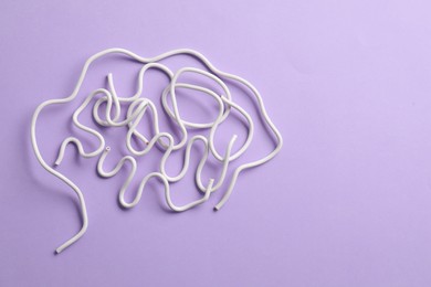 Photo of Amnesia problem. Brain made of wires on violet background, top view. Space for text