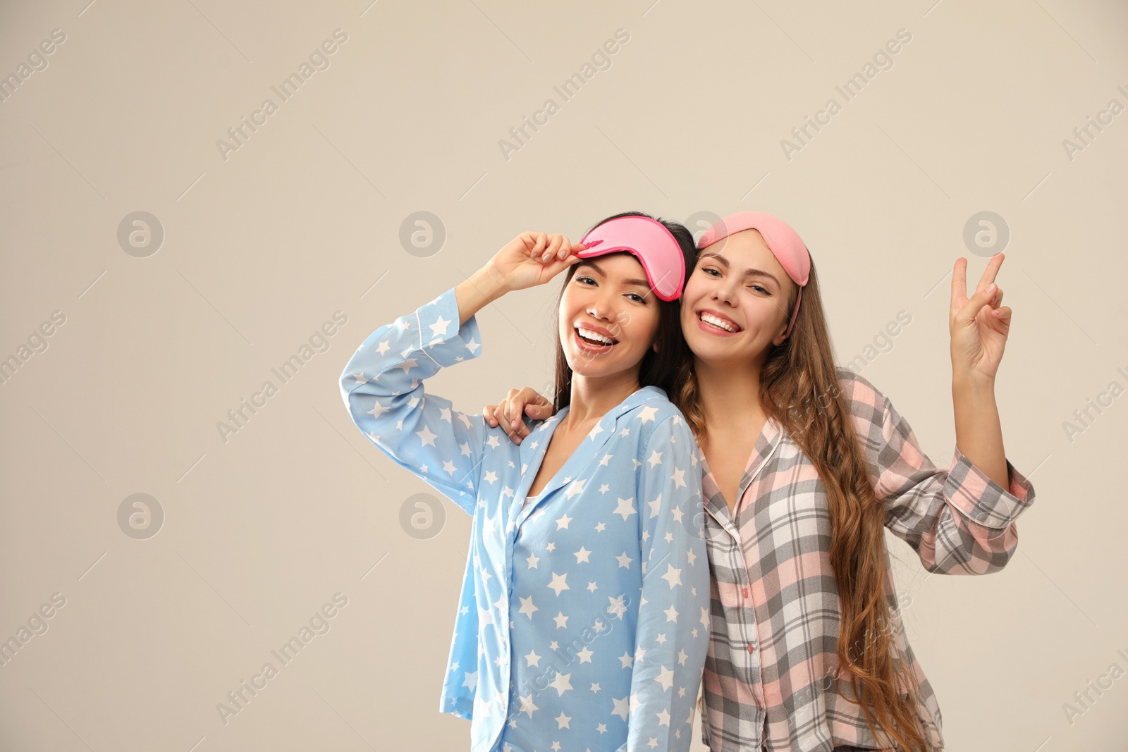 Photo of Beautiful women in pajamas on beige background. Bedtime