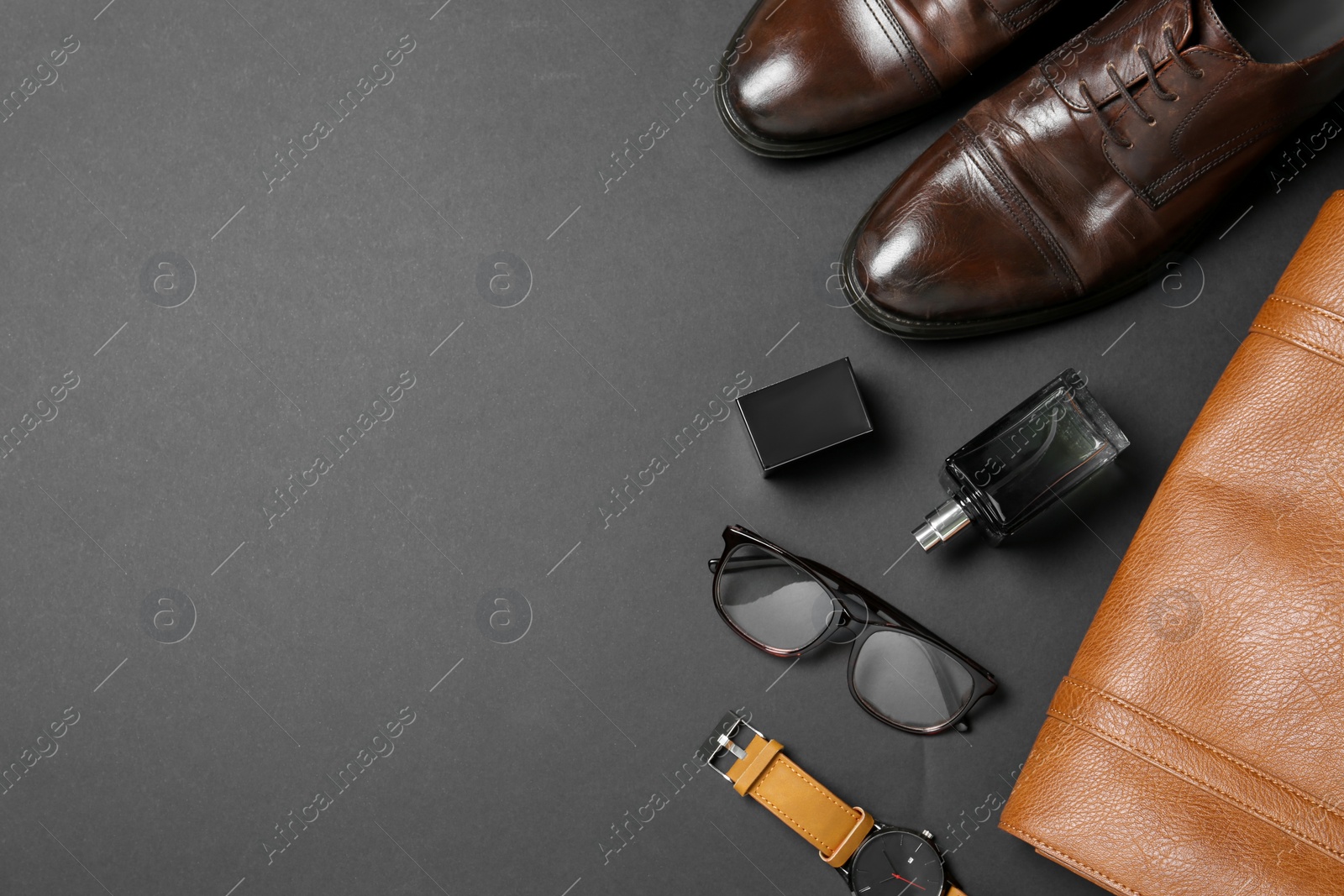 Photo of Stylish shoes and accessories on black background, space for text