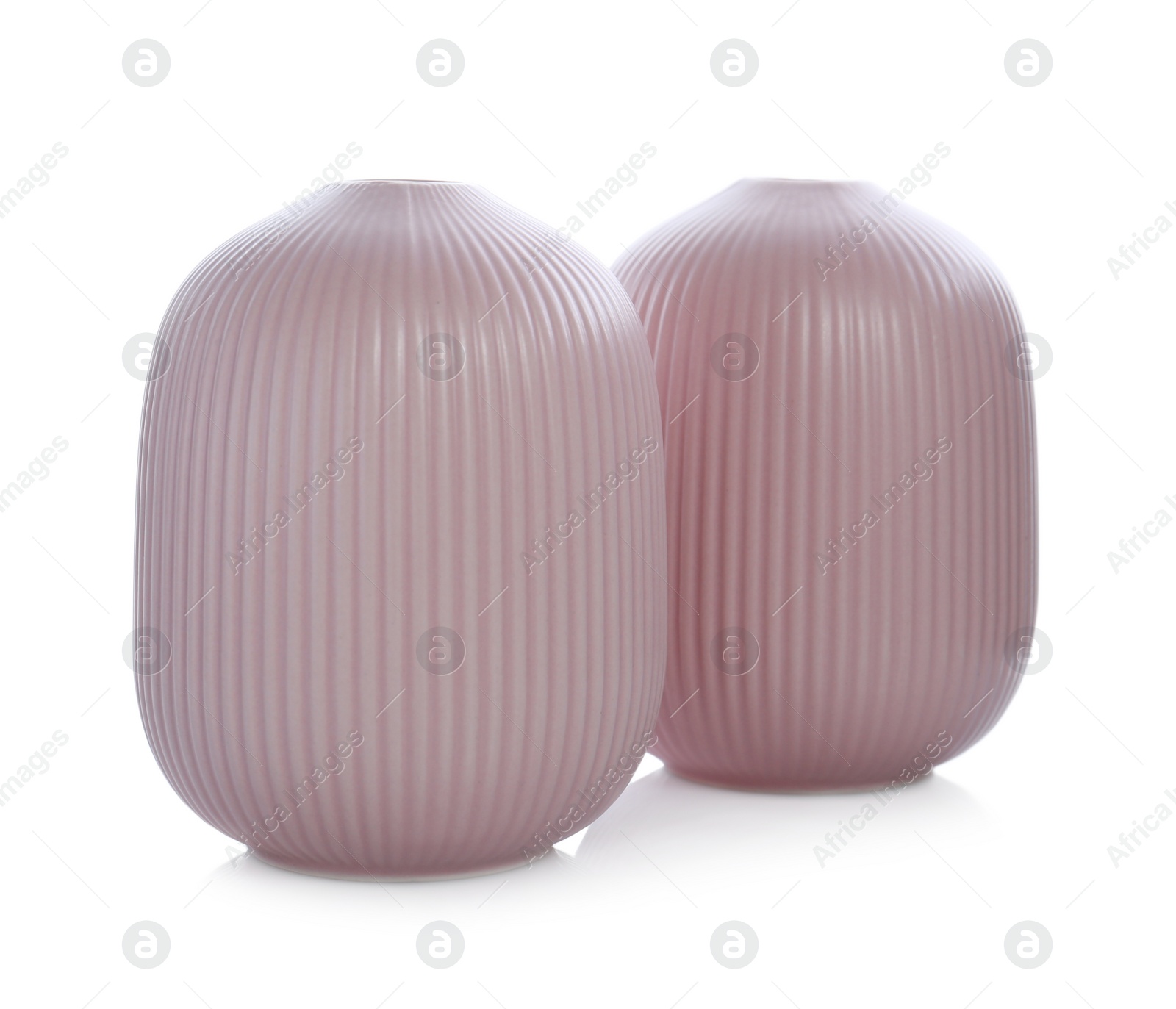 Photo of Stylish empty pink ceramic vases isolated on white