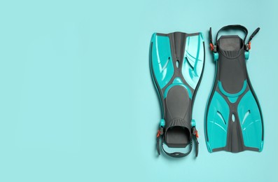 Pair of flippers on color background, flat lay