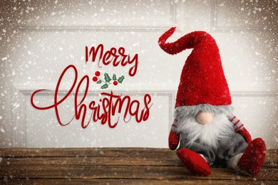 Image of Merry Christmas! Cute gnome on wooden table