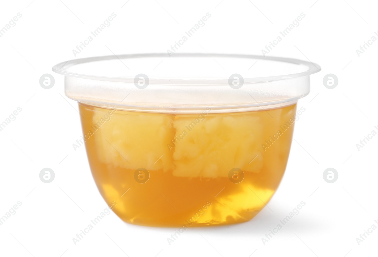 Photo of Tasty jelly dessert with slices of fruit in plastic cup on white background