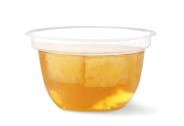 Photo of Tasty jelly dessert with slices of fruit in plastic cup on white background