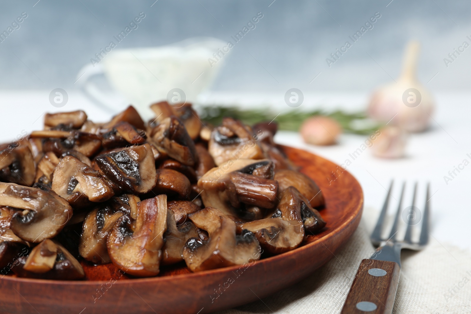 Photo of Plate of fried mushrooms on table, closeup. Space for text