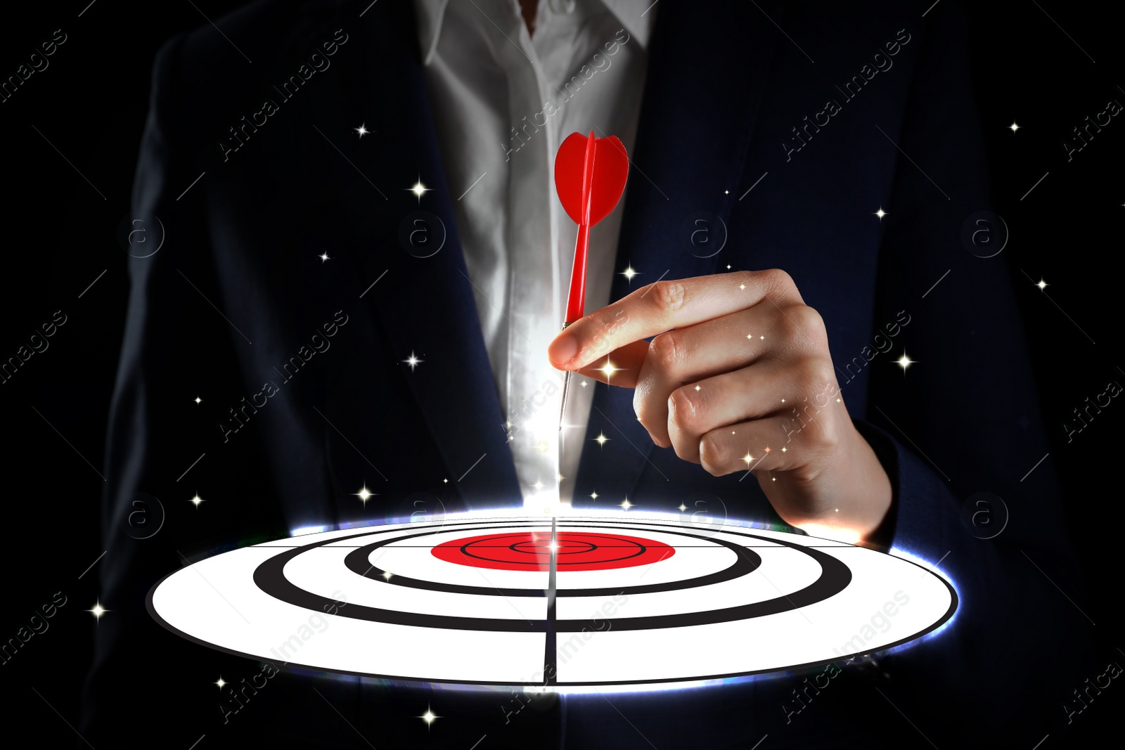 Image of Businesswoman aiming at digital target with dart against dark background, closeup