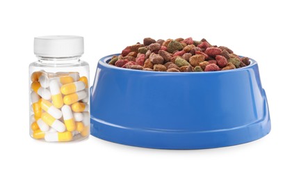 Image of Dry pet food in feeding bowl and bottle with vitamin pills on white background