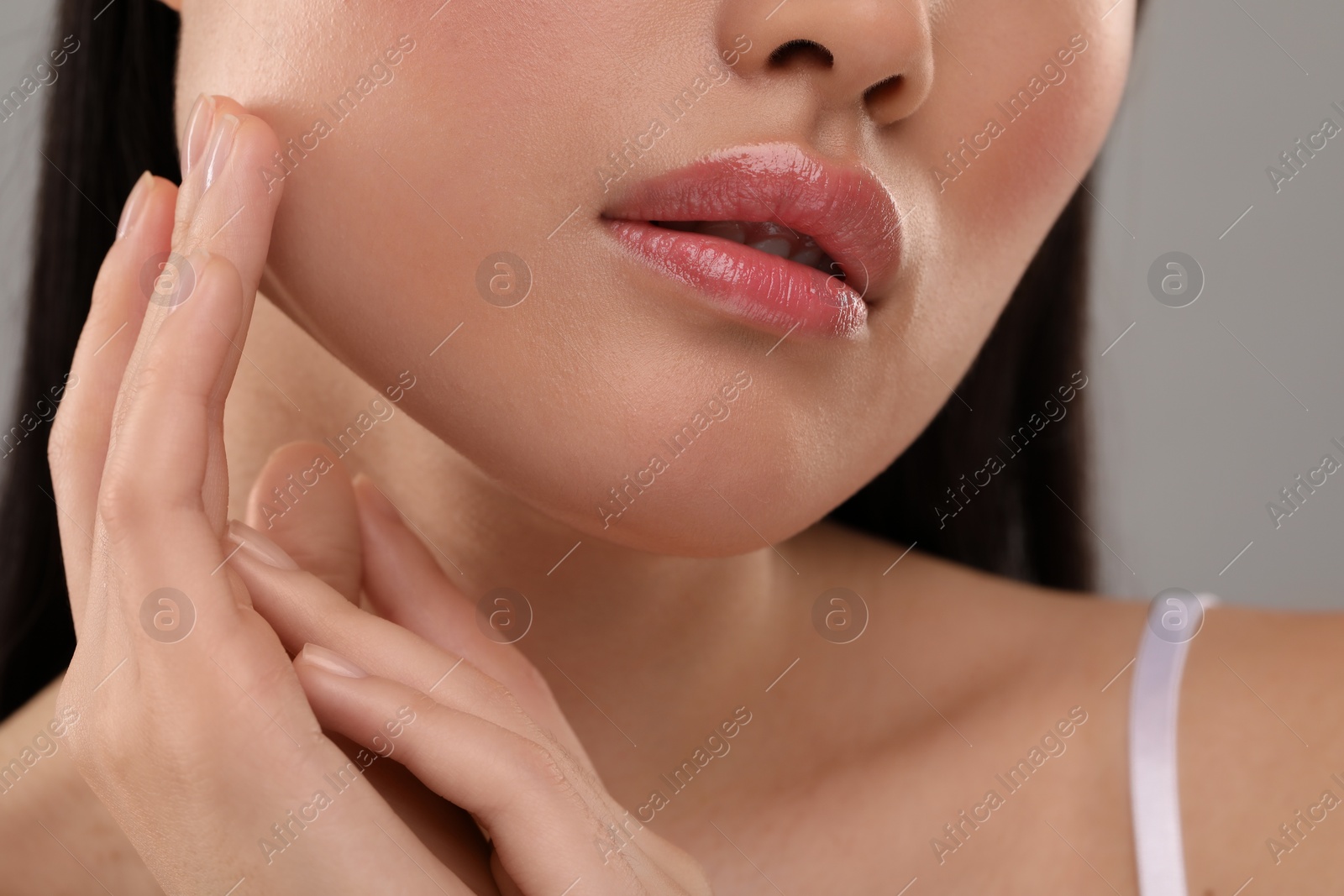 Photo of Beautiful woman with healthy skin on gray background, closeup