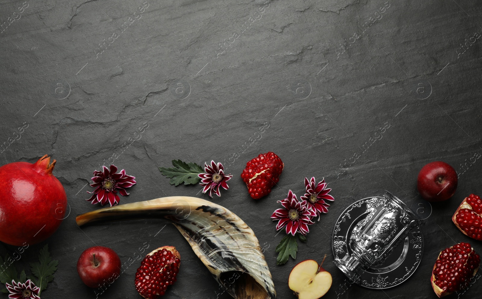Photo of Flat lay composition with Rosh Hashanah holiday attributes on black background. Space for text
