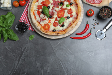 Photo of Delicious pizza Diablo on grey table, flat lay. Space for text
