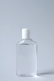 Photo of Bottle of cosmetic product on light grey background
