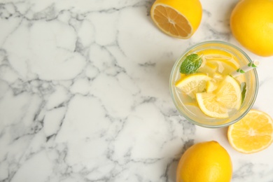 Photo of Cool freshly made lemonade and fruits on white marble table, flat lay. Space for text