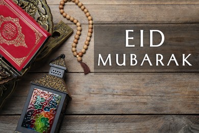 Image of Eid Mubarak greeting card. Arabic lantern, Quran and misbaha on wooden background, flat lay