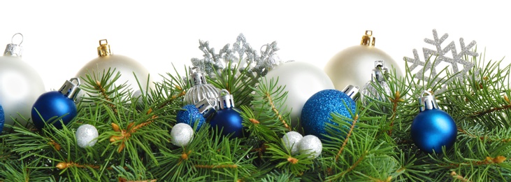 Photo of Fir tree branches with Christmas decoration on white background