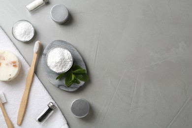 Photo of Flat lay composition with tooth powder and mint on grey table, space for text