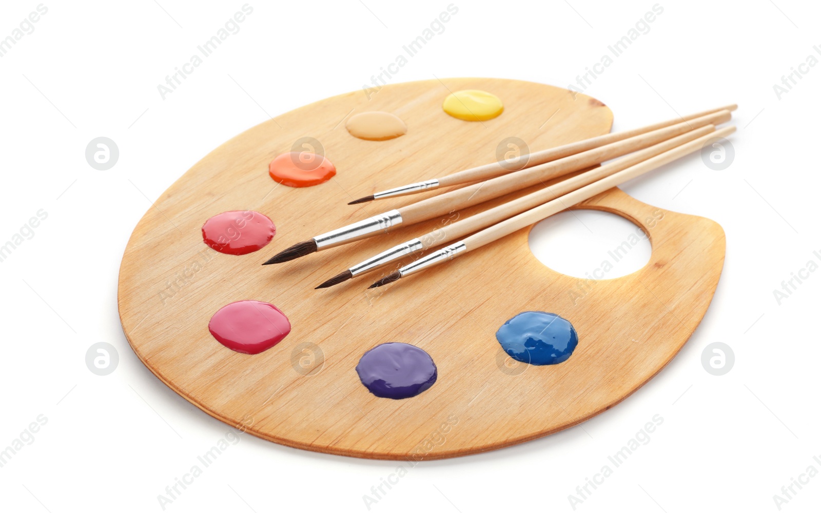 Photo of Palette with paints and brushes on white background