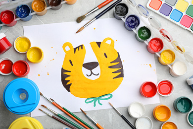 Photo of Flat lay composition with child's painting of tiger on marble table
